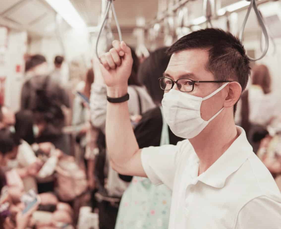 Electronic contract manufacturing worker wearing a mask to protect against COVID-19