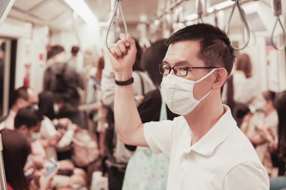 Electronic contract manufacturing worker wearing a mask to protect against COVID-19